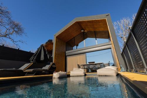 a house with a swimming pool next to a fence at Spa Villas Nafpaktos in Nafpaktos