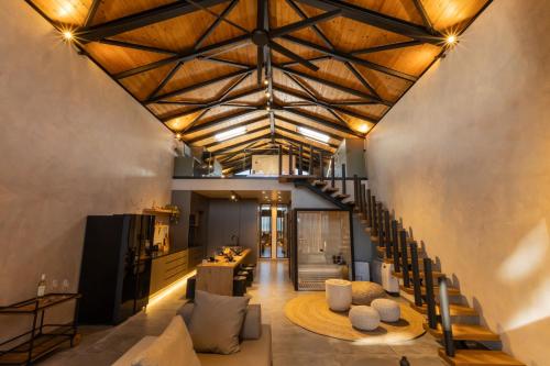 an open living room with a wooden ceiling at Spa Villas Nafpaktos in Nafpaktos