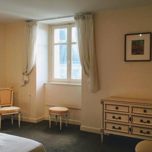 une chambre avec un lit, une commode et une fenêtre dans l'établissement Villa Castalie - Maison de maître, grande piscine et jacuzzi, classée 5 étoiles, à Montrichard