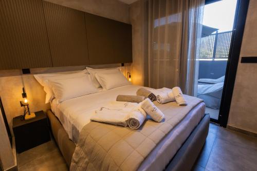 a hotel room with a bed with towels on it at Spa Villas Nafpaktos in Nafpaktos