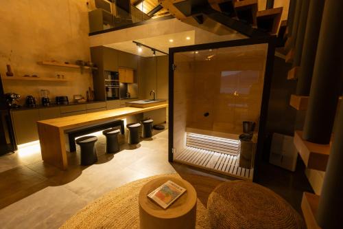 a kitchen with a shower and a table in a room at Spa Villas Nafpaktos in Nafpaktos