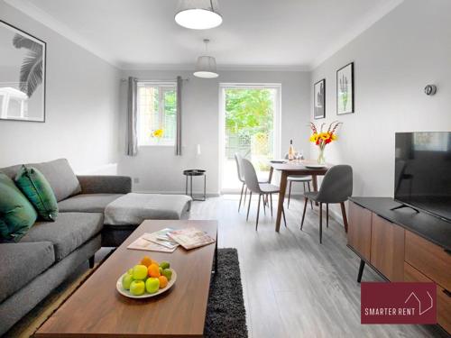 a living room with a couch and a table at Knaphill - 2 Bed House - Private Garden & Parking in Brookwood