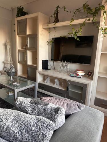 a living room with a tv and a couch and a table at Medina del descanso in Medina de Pomar