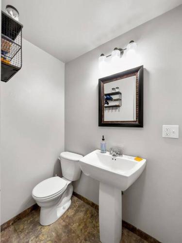 a white bathroom with a toilet and a sink at Hottub Hideaway BHBungalows #6 in Custer