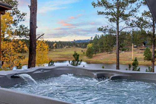 a hot tub with water coming out of it at Hottub Hideaway BHBungalows #6 in Custer