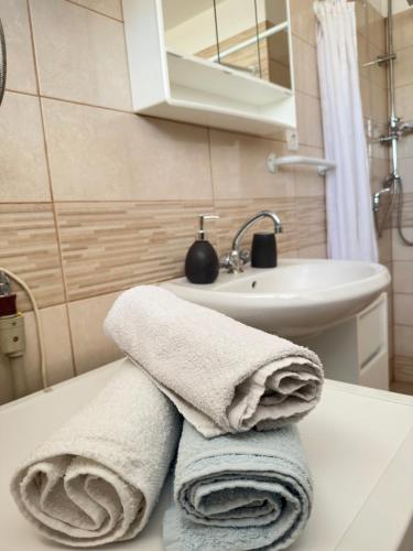 a bathroom with towels sitting on a counter next to a sink at Apartment Maky in Zadar