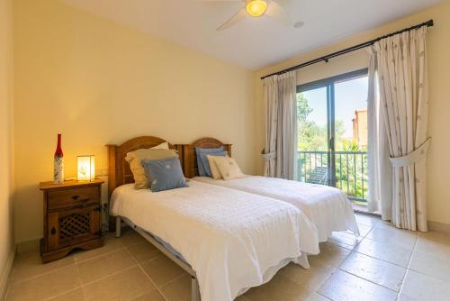 a bedroom with a bed and a large window at Royal Flamingos Sea View Apartman in Estepona