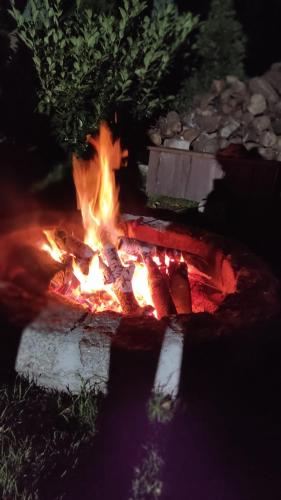a fire pit in the middle of a yard at night at Domki u Justyny Podgórzyn Karpacz Sosnówka in Podgórzyn