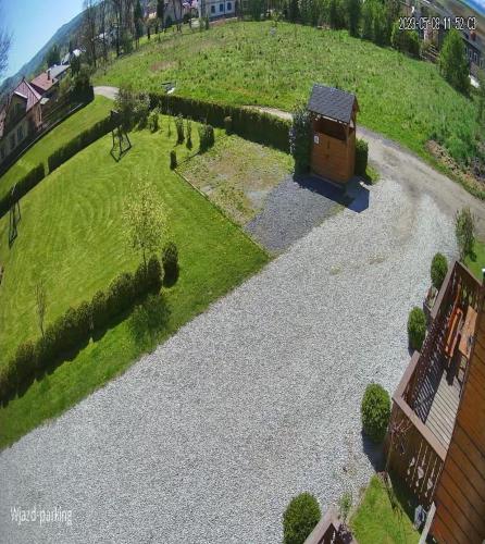 a garden with a small house on a hill at Domki u Justyny Podgórzyn Karpacz Sosnówka in Podgórzyn