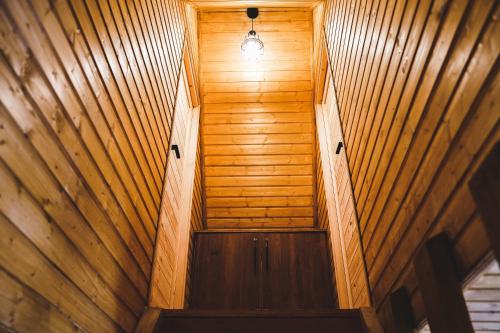 an overhead view of a wooden hallway with a light at RestArt Cottages in Kazbegi in Stepantsminda