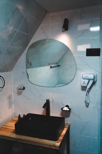 a bathroom with a mirror and a sink at RestArt Cottages in Kazbegi in Stepantsminda