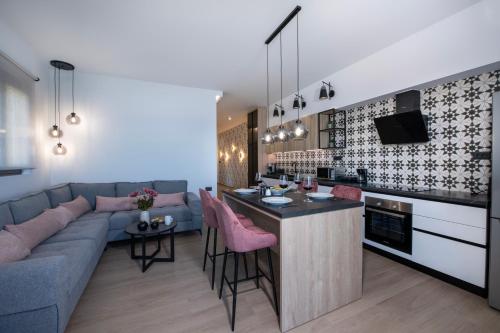 a kitchen and living room with a couch and a bar at ALPHA SUITES in Chania Town