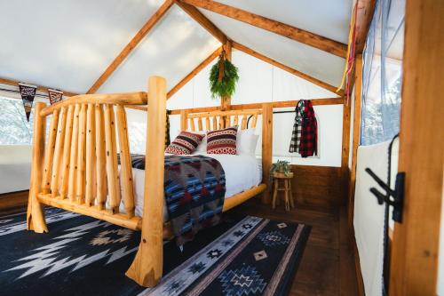 a bedroom with a bed in a tent at Sundance By Basecamp in Kananaskis Village