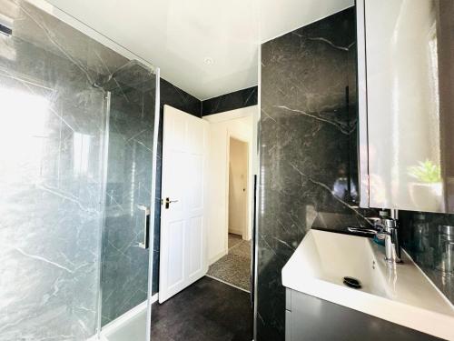 a bathroom with a sink and a shower at Tillicoultry Jupiter Apartment - Scotland Holiday Let in Tillicoultry