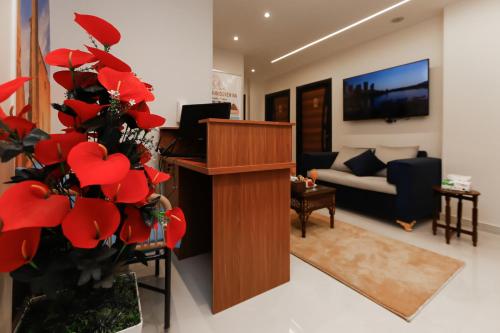 a living room with red flowers and a podium at Diamond Pyramids View Inn in Cairo