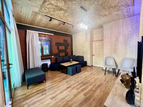 a living room with a couch and a table and chairs at Milenium magic villas on Sevan beach in Sevan