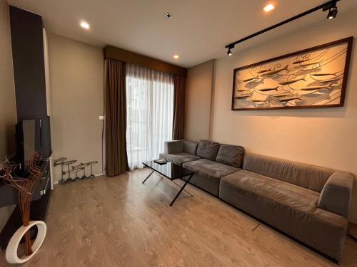 a living room with a couch and a television at Sea View 2 Bed Room Condo @ Central Pattaya in Pattaya Central