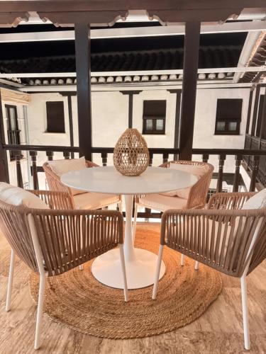 a table and chairs on a balcony at MANZANO PALACE. Apartamentos con Terraza in Almagro