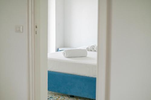 a bedroom with a bed in a room with a mirror at Casa Flora in Vietri sul Mare