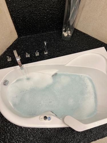 a bath tub filled with water in a sink at Golden King Villas in Vassilias