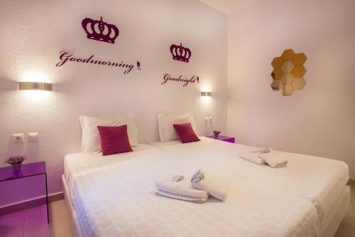 a bedroom with a bed with towels on it at Golden King Villas in Vassilias