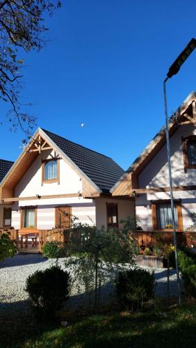 a large white house with a black roof at Domki u Justyny Podgórzyn Karpacz Sosnówka in Podgórzyn
