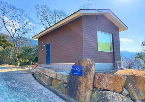 a small house with a blue sign in front of it at BLUE AMALFI - Vacation STAY 91483v in Ōbe