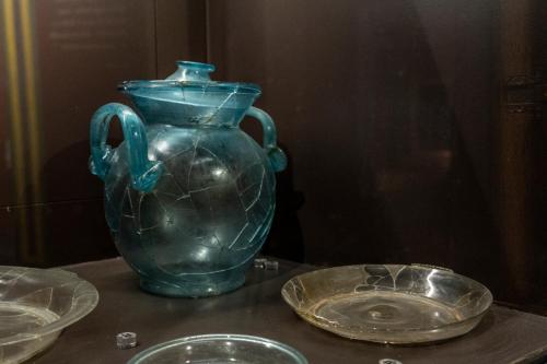 a blue vase sitting on top of a table with plates at Palazzo Oddo Rental Rooms in Albenga