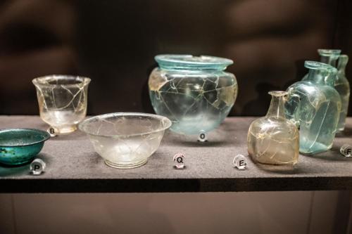 a group of glass vases and bowls on a table at Palazzo Oddo Rental Rooms in Albenga