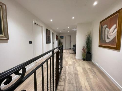 a hallway with white walls and a black railing at SAINT MICHEL in Gorizia