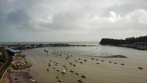 an aerial view of a beach with boats in the water at Historic 'Old Toll House' Shaldon Bridge in Teignmouth