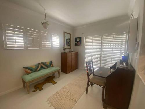 a living room with a couch and a table and a chair at Closest Studio Suite to Vanderbilt Beach, new remodel, well appointed, BBQ, yard, very private plus many extras! in Naples