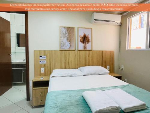 Cama o camas de una habitación en Residencial 364 - Localização privilegiada à 5min da praia