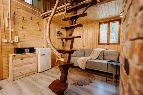 a living room with a couch and a refrigerator in a cabin at Mountain View Tiny House in Lacu Rosu