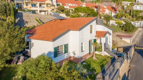 an aerial view of a white house with an orange roof at SUNSET VILLA in Caniço