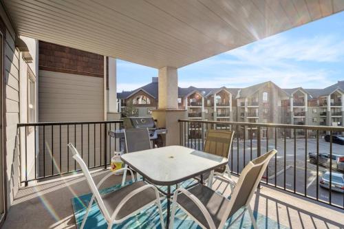 a patio with a table and chairs on a balcony at Lakeside Memories, Pool, Hot Tub, Central in Invermere