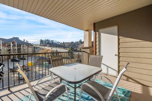 a patio with a table and chairs on a balcony at Lakeside Memories, Pool, Hot Tub, Central in Invermere