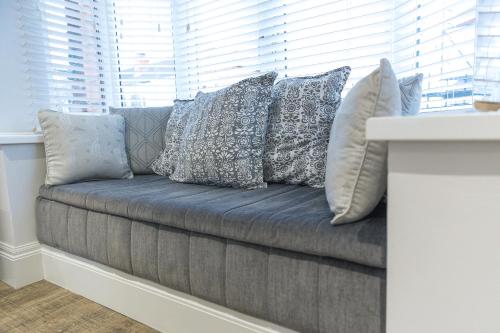 a couch with pillows on it in a window at Jalebo in Cleethorpes