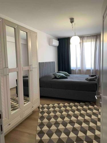 um quarto com uma cama e uma grande janela em Нощувки Хранова em Plovdiv