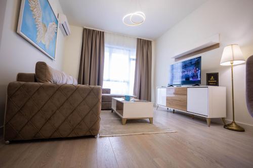 a living room with a couch and a tv at Apartments Royal - Belgrade Waterfront in Belgrade