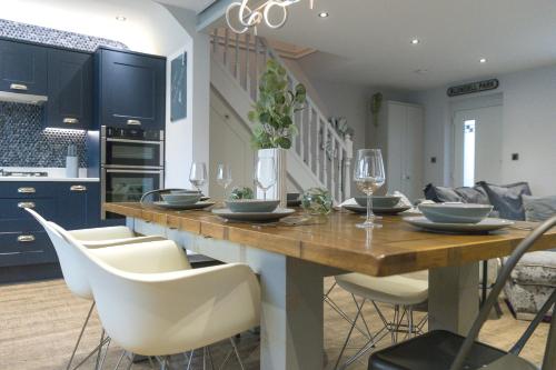 a kitchen and dining room with a wooden table and chairs at Jalebo in Cleethorpes
