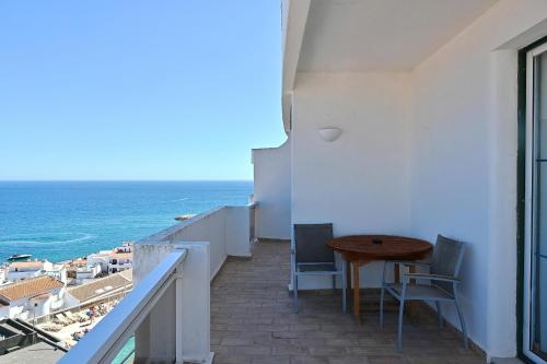 a balcony with a table and a view of the ocean at Boa Vista Hotel & Spa - Adults Only in Albufeira