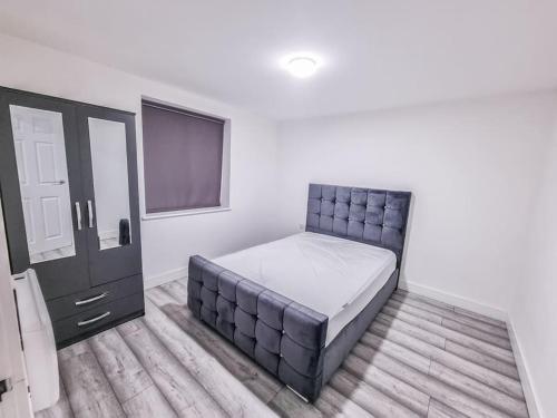 a bedroom with a bed and a flat screen tv at Elegant City Apt: 1-BR Luxury in Wolverhampton