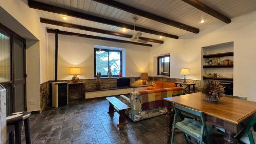 a living room with a couch and a table at Villa Luxury nel Bosco in Castelbuono