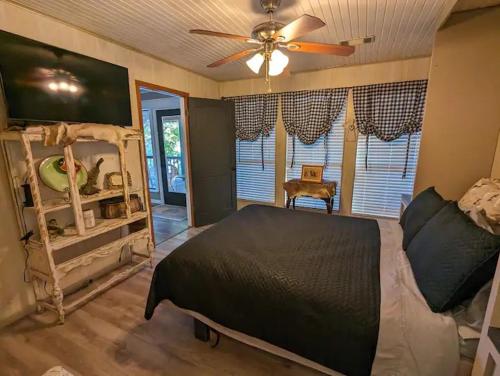 a bedroom with a bed and a ceiling fan at Robbins Nest in South Toledo Bend