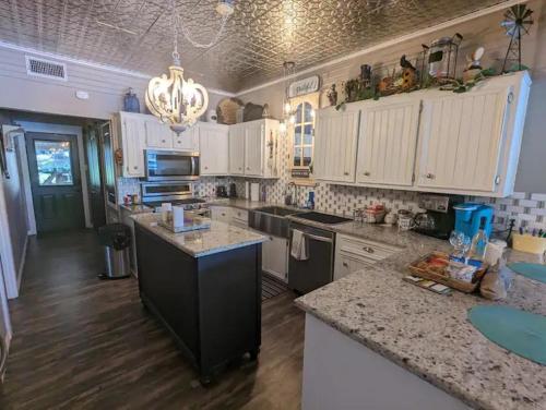 a large kitchen with white cabinets and a counter top at Robbins Nest in South Toledo Bend