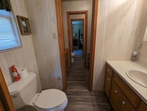 a small bathroom with a toilet and a sink at Robbins Nest in South Toledo Bend