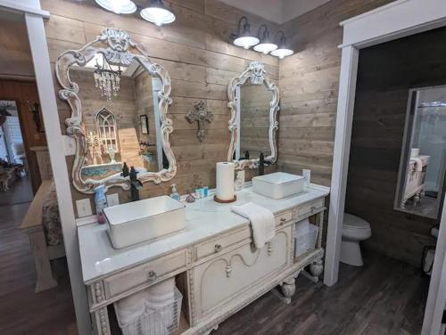 a bathroom with two sinks and a mirror at Robbins Nest in South Toledo Bend