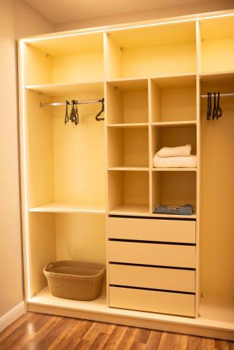 a walk in closet with white shelves at Munir’s residence in Cairo