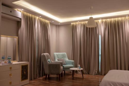 a hotel room with two chairs and a bed at Munir’s residence in Cairo